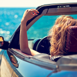 Women in an insured car by a Florida beach.