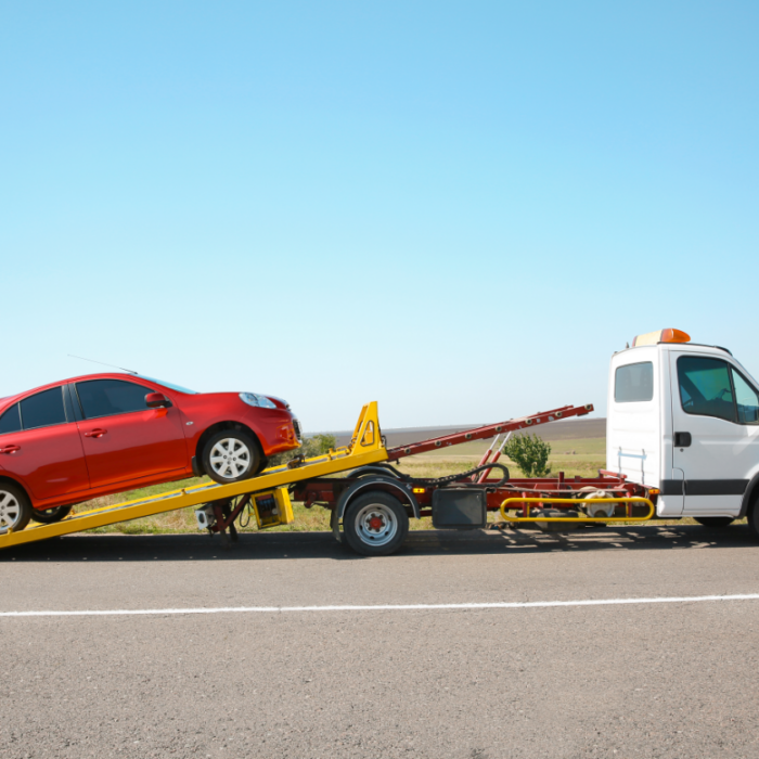Car being loaded onto a tow truck