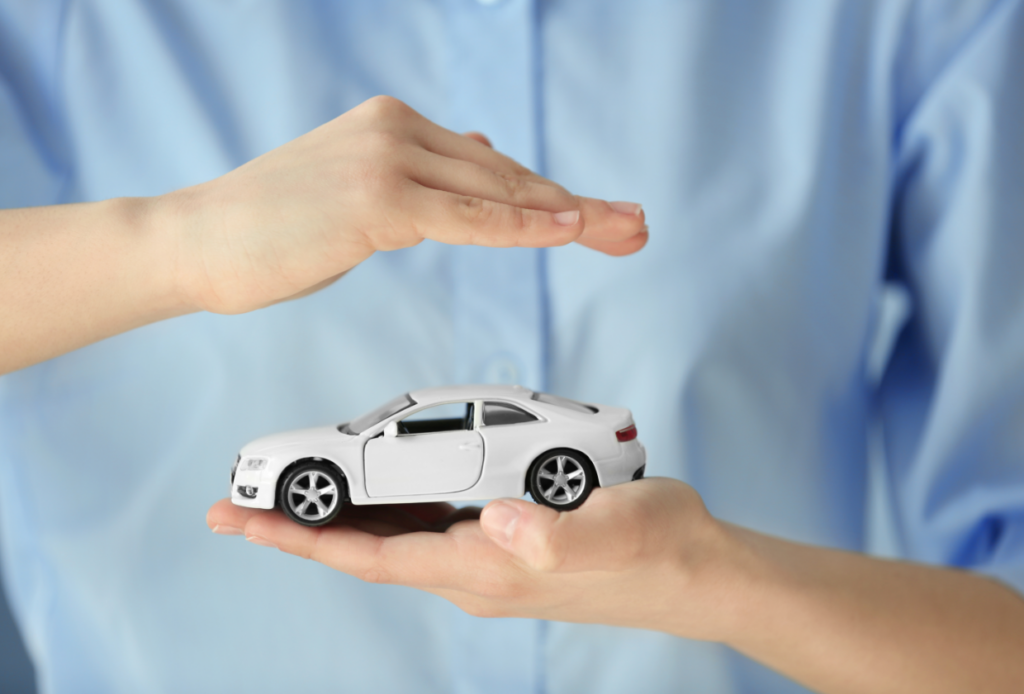 Woman holding a toy car in her hand, symbolizing protection and security after car insurance cancellation