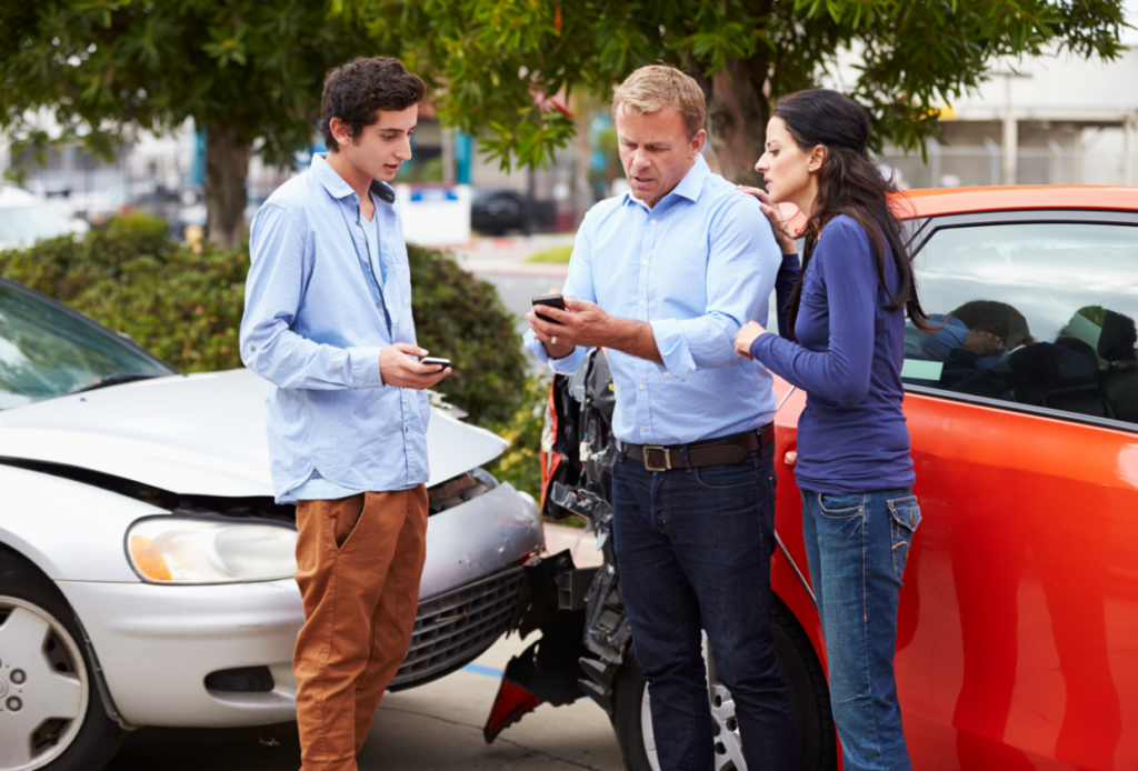 Drivers exchanging insurance information after an accident