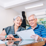 Senior couple reading about Medicare Giveback Benefit