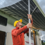 RV owner prepping for rain by putting up awning