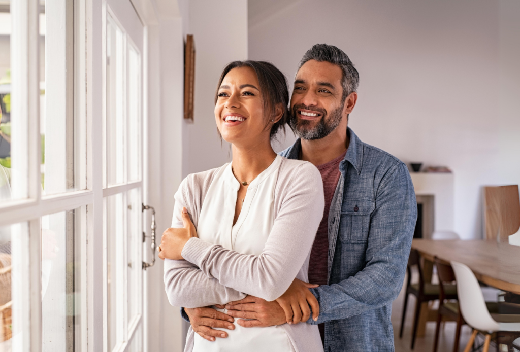 Happy couple relaxing at home after securing a joint insurance policy