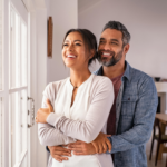 Happy couple relaxing at home after securing a joint insurance policy