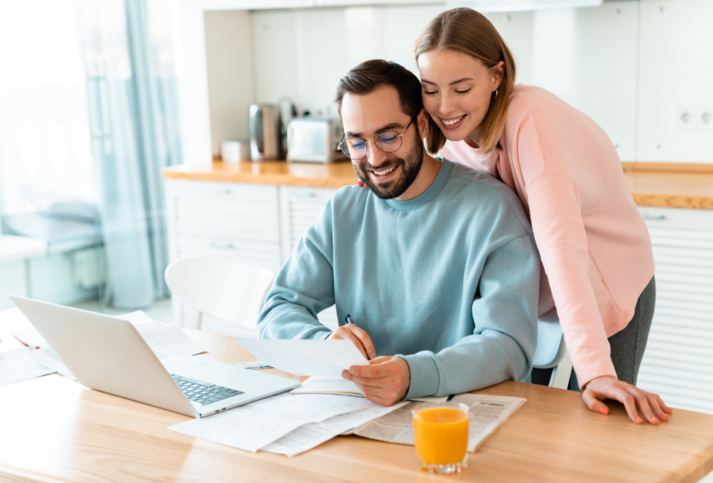 Couple considering switching insurance companies while looking over current insurance policy